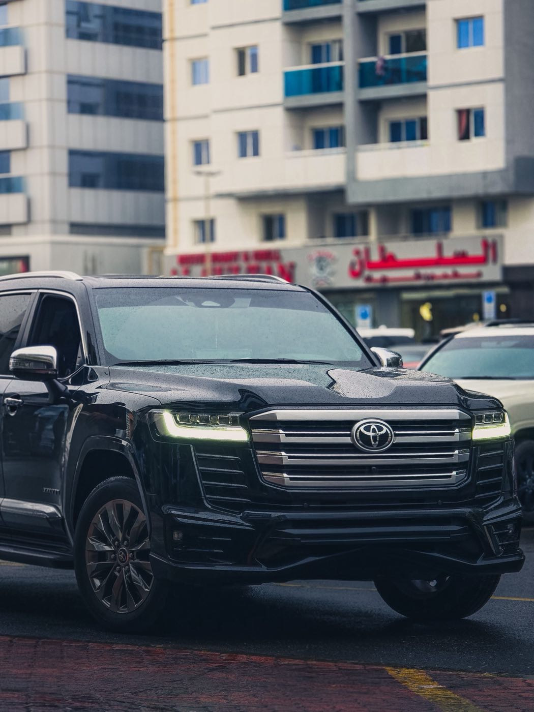 Black Toyota Land Cruiser 300 on a city street