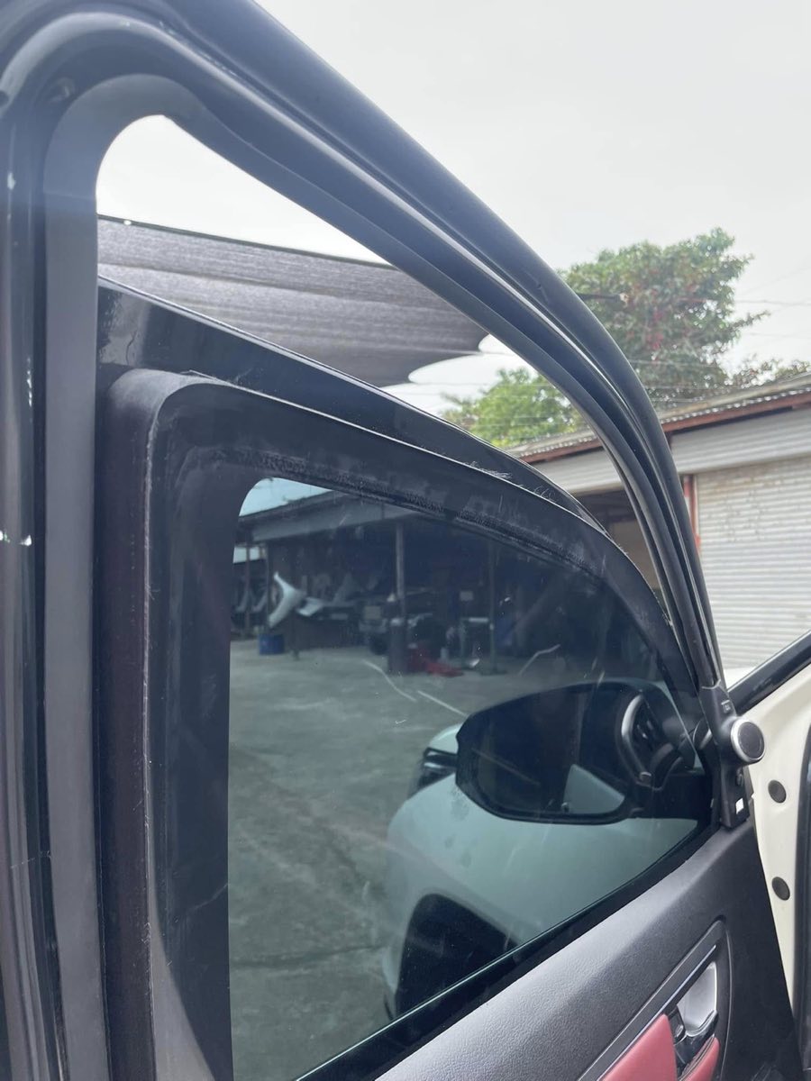 Close view of multi-layer ballistic glass fitted into a vehicle window frame